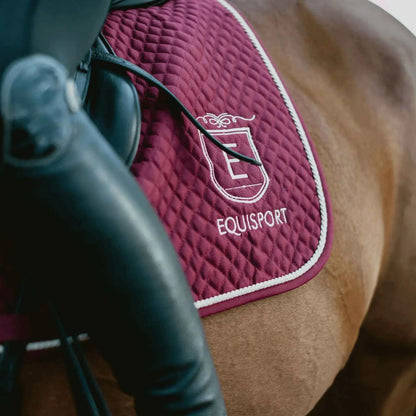 Equisport Equestrian Classic Saddle Pad in burgundy, designed for comfort and protection during equestrian activities.