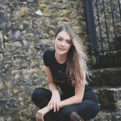 Model wearing Equisport Equestrian Sports T-Shirt, stylish look with nature backdrop.